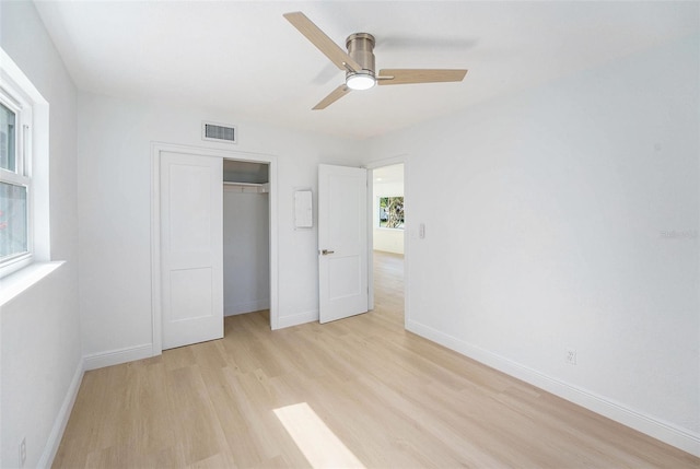 1601 Paloma Ln, Dunedin, FL 34698 - unfurnished bedroom with light wood-type flooring, a closet, and ceiling fan