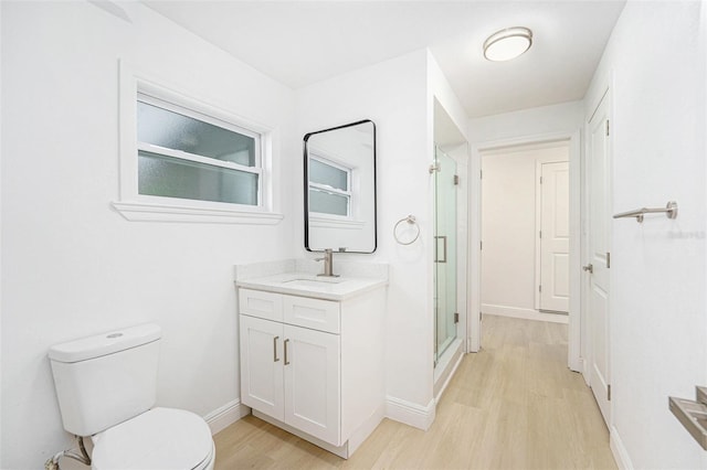 1601 Paloma Ln, Dunedin, FL 34698 - bathroom with wood finished floors, vanity, and a stall shower