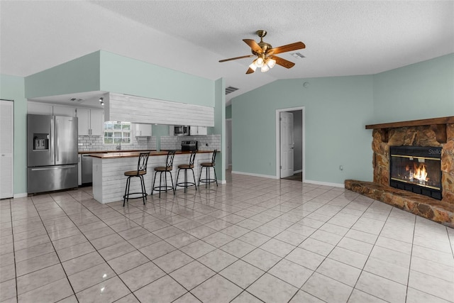 5112 Odin St, Spring Hill, FL 34608 - kitchen with appliances with stainless steel finishes, open floor plan, a peninsula, lofted ceiling, and decorative backsplash