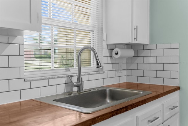 5112 Odin St, Spring Hill, FL 34608 - kitchen with tasteful backsplash, white cabinets, and dark countertops