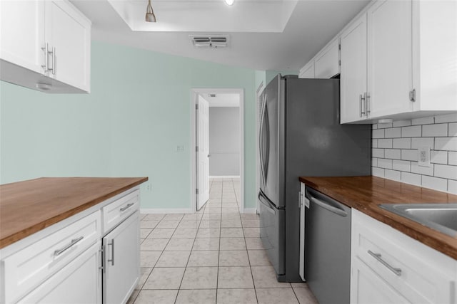 5112 Odin St, Spring Hill, FL 34608 - kitchen with stainless steel dishwasher, wood counters, backsplash, white cabinets, and light tile patterned flooring