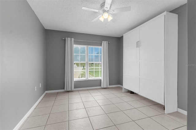 5112 Odin St, Spring Hill, FL 34608 - spare room with a textured ceiling, ceiling fan, and light tile patterned floors