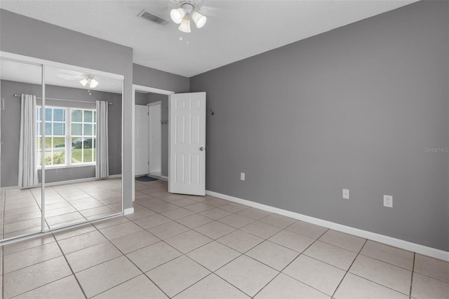 5112 Odin St, Spring Hill, FL 34608 - unfurnished bedroom featuring light tile patterned floors, a closet, and a ceiling fan
