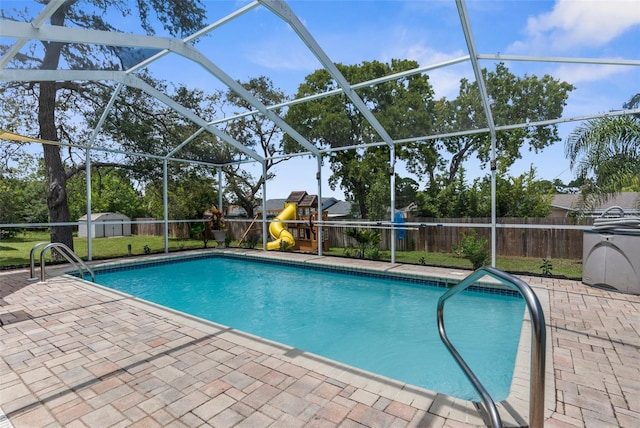 5112 Odin St, Spring Hill, FL 34608 - view of swimming pool with a playground, a patio, a fenced backyard, and a shed