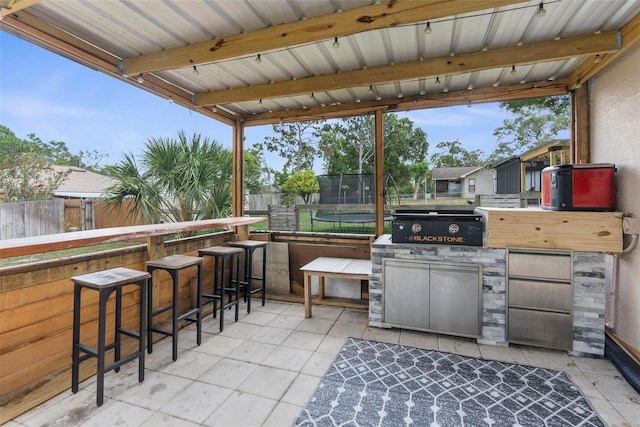 5112 Odin St, Spring Hill, FL 34608 - view of patio featuring a trampoline and exterior kitchen
