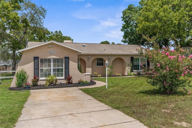5112 Odin St, Spring Hill, FL 34608 - ranch-style house featuring stucco siding, a front yard, and driveway