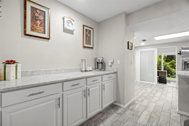 3323 Fox Hunt Dr, Palm Harbor, FL 34683 - bar area with a textured ceiling and wood tiled floors