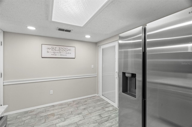 3323 Fox Hunt Dr, Palm Harbor, FL 34683 - kitchen featuring stainless steel refrigerator with ice dispenser, a textured ceiling, and recessed lighting