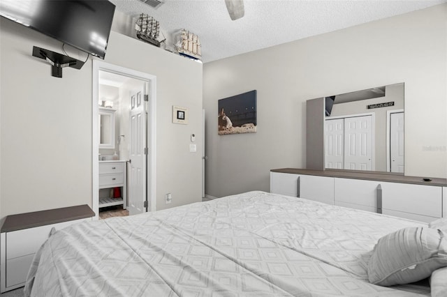 3323 Fox Hunt Dr, Palm Harbor, FL 34683 - bedroom featuring a textured ceiling, ensuite bathroom, and ceiling fan