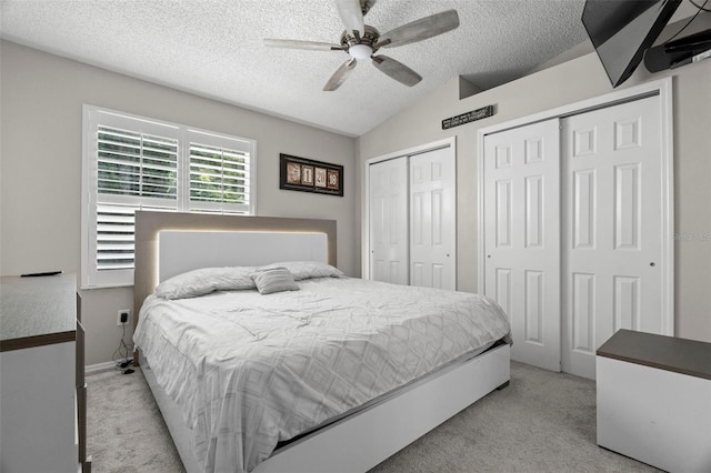 3323 Fox Hunt Dr, Palm Harbor, FL 34683 - bedroom featuring carpet flooring, multiple closets, lofted ceiling, a textured ceiling, and ceiling fan