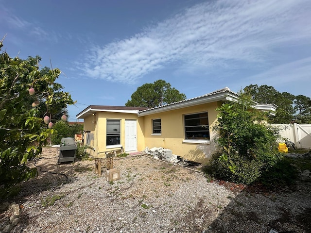 view of front of property with stucco siding and a tile roof