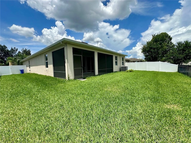 10621 Scenic Hollow Dr, Riverview, FL 33578 - back of house featuring a sunroom, a fenced backyard, and stucco siding