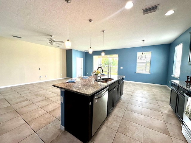 10621 Scenic Hollow Dr, Riverview, FL 33578 - kitchen with dark cabinets, dishwasher, dark stone countertops, ceiling fan, and a kitchen island with sink