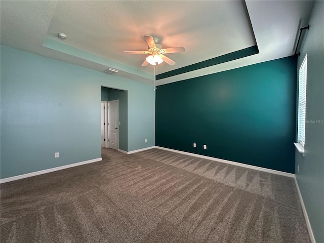 10621 Scenic Hollow Dr, Riverview, FL 33578 - carpeted empty room featuring a tray ceiling, a ceiling fan, and a smoke detector