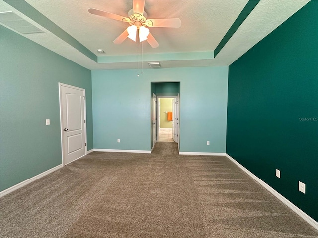 10621 Scenic Hollow Dr, Riverview, FL 33578 - unfurnished bedroom featuring a tray ceiling, dark colored carpet, a textured ceiling, and a ceiling fan
