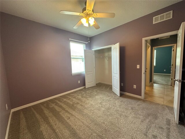 10621 Scenic Hollow Dr, Riverview, FL 33578 - unfurnished bedroom featuring carpet, a closet, and a ceiling fan
