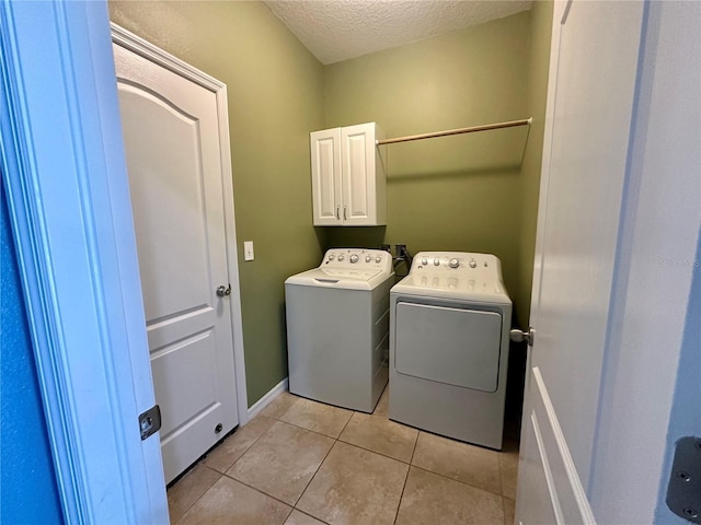 10621 Scenic Hollow Dr, Riverview, FL 33578 - laundry room featuring cabinet space, a textured ceiling, independent washer and dryer, and light tile patterned floors
