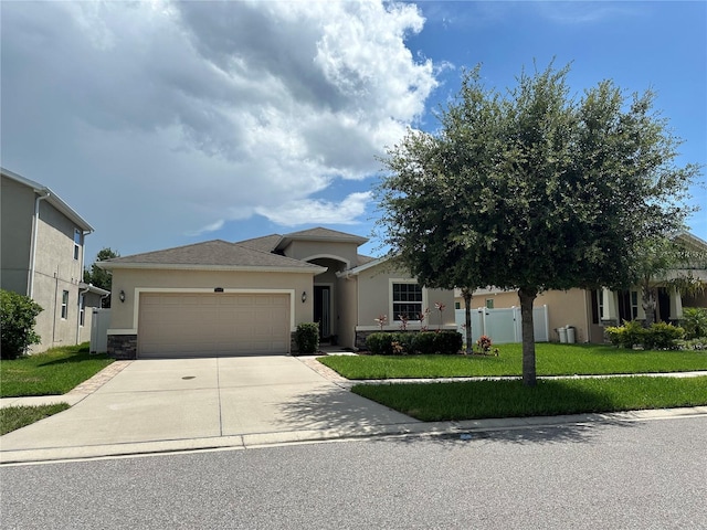 10621 Scenic Hollow Dr, Riverview, FL 33578 - view of front facade featuring stucco siding, a garage, concrete driveway, and stone siding