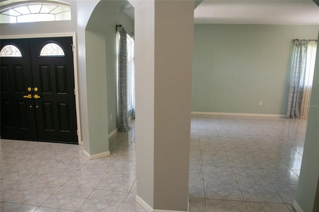 25435 Bruford Blvd, Land O Lakes, FL 34639 - foyer with arched walkways and light tile patterned floors