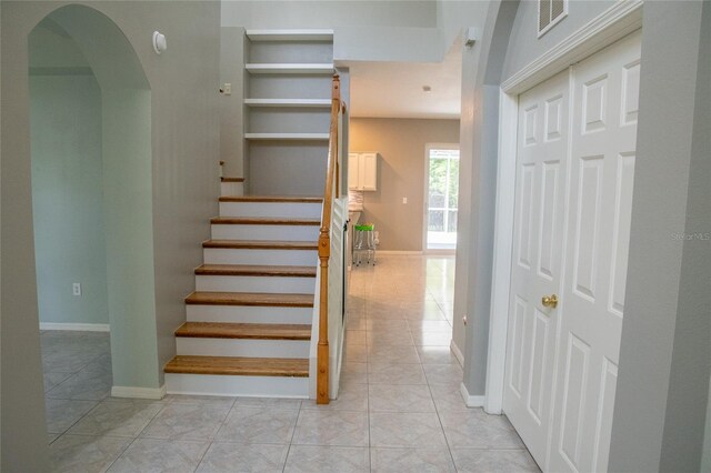 25435 Bruford Blvd, Land O Lakes, FL 34639 - stairway with tile patterned floors and arched walkways