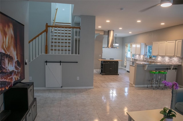 25435 Bruford Blvd, Land O Lakes, FL 34639 - kitchen featuring wall chimney exhaust hood, white cabinetry, recessed lighting, decorative backsplash, and ceiling fan