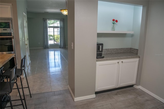 25435 Bruford Blvd, Land O Lakes, FL 34639 - kitchen featuring appliances with stainless steel finishes, open shelves, and white cabinetry