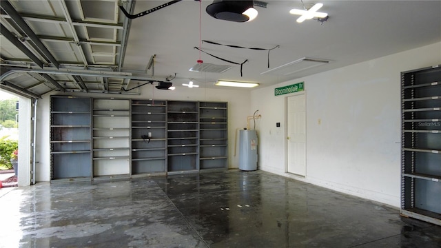 25435 Bruford Blvd, Land O Lakes, FL 34639 - garage featuring water heater and a garage door opener