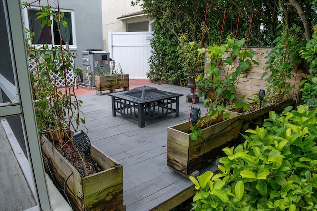25435 Bruford Blvd, Land O Lakes, FL 34639 - wooden terrace featuring a vegetable garden and an outdoor fire pit