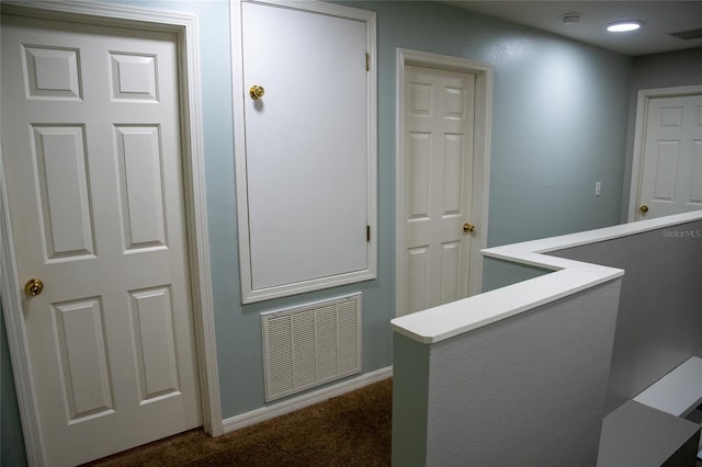 25435 Bruford Blvd, Land O Lakes, FL 34639 - hallway featuring dark carpet and baseboards