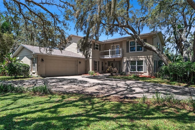 1310 Rustlewood Dr, Brandon, FL 33510 - view of front of house featuring a balcony, driveway, brick siding, an attached garage, and a front yard