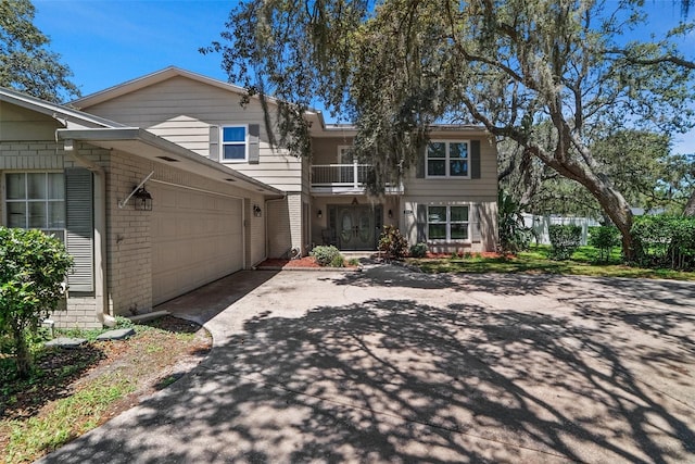 1310 Rustlewood Dr, Brandon, FL 33510 - view of front facade with brick siding, driveway, a garage, and a balcony