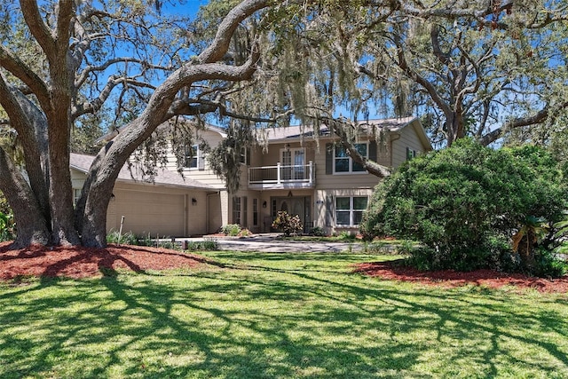 1310 Rustlewood Dr, Brandon, FL 33510 - view of front of property featuring a balcony, a front lawn, driveway, and an attached garage