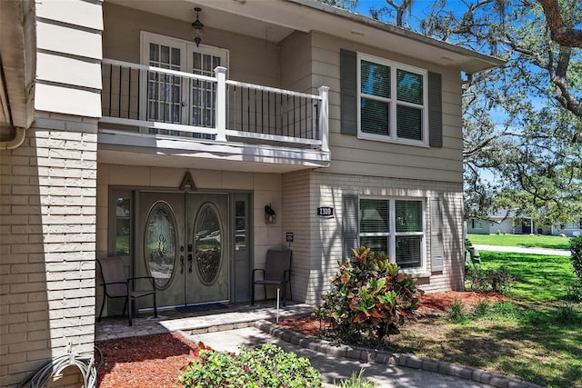 1310 Rustlewood Dr, Brandon, FL 33510 - view of exterior entry featuring a balcony and french doors