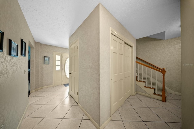 1310 Rustlewood Dr, Brandon, FL 33510 - hall with a textured ceiling, light tile patterned floors, and stairs