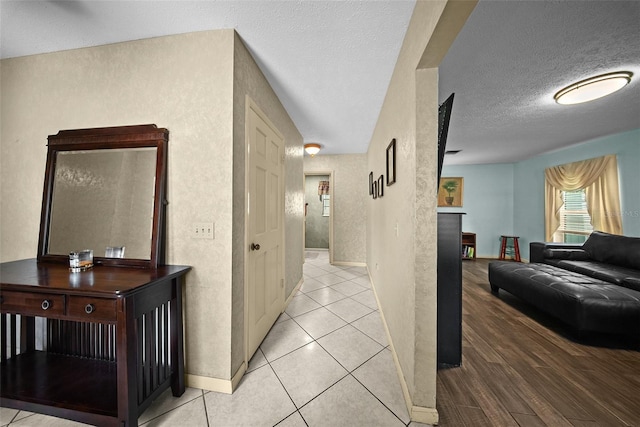 1310 Rustlewood Dr, Brandon, FL 33510 - hallway featuring a textured ceiling and light tile patterned floors