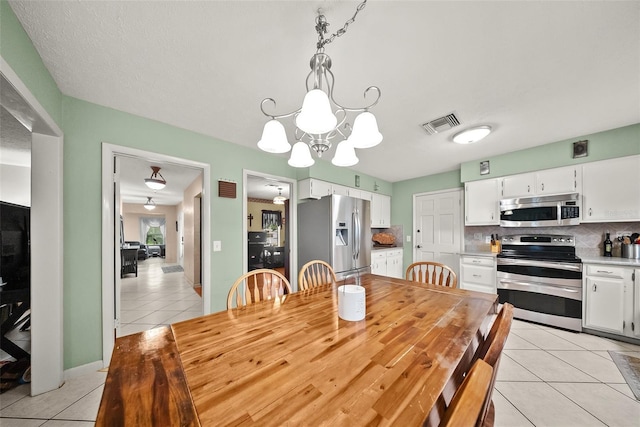 1310 Rustlewood Dr, Brandon, FL 33510 - dining space with light tile patterned floors and a chandelier