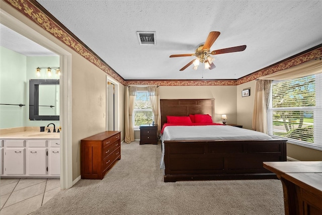1310 Rustlewood Dr, Brandon, FL 33510 - bedroom with a textured ceiling, ensuite bathroom, light colored carpet, and a ceiling fan