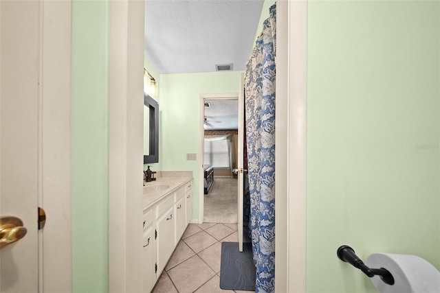 1310 Rustlewood Dr, Brandon, FL 33510 - full bathroom with vanity, tile patterned floors, a textured ceiling, and ensuite bathroom