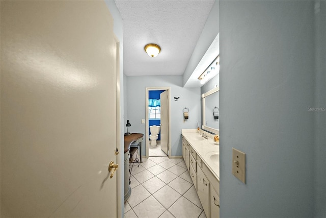 1310 Rustlewood Dr, Brandon, FL 33510 - bathroom featuring double vanity, tile patterned flooring, and a textured ceiling