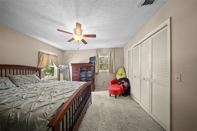 1310 Rustlewood Dr, Brandon, FL 33510 - bedroom with carpet, multiple windows, a closet, a textured ceiling, and a ceiling fan