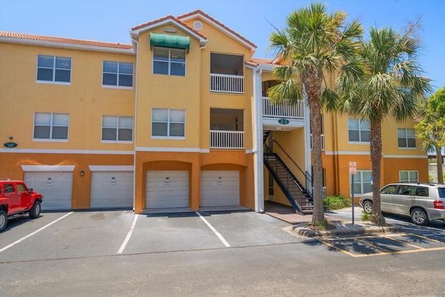 10764 70th Ave Unit 4305, Seminole, FL 33772 - view of building exterior featuring stairs and an attached garage