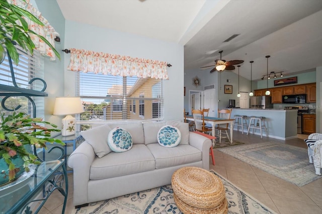 10764 70th Ave Unit 4305, Seminole, FL 33772 - living area with light tile patterned flooring, lofted ceiling, ceiling fan, and track lighting