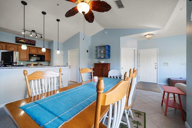 10764 70th Ave Unit 4305, Seminole, FL 33772 - dining area with ceiling fan, vaulted ceiling, and light tile patterned flooring