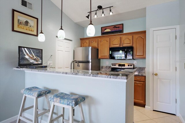 10764 70th Ave Unit 4305, Seminole, FL 33772 - kitchen featuring black microwave, freestanding refrigerator, white electric range oven, a kitchen bar, and light tile patterned floors