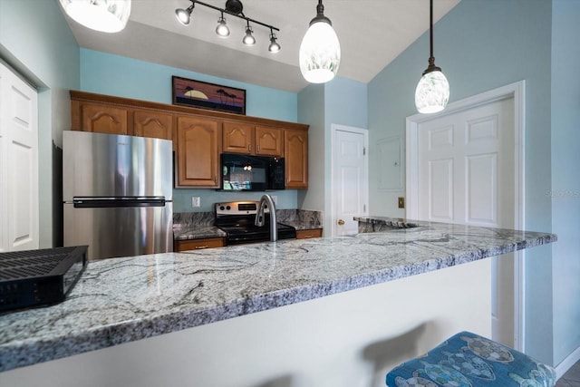 10764 70th Ave Unit 4305, Seminole, FL 33772 - kitchen with freestanding refrigerator, black microwave, range with electric cooktop, decorative light fixtures, and brown cabinetry