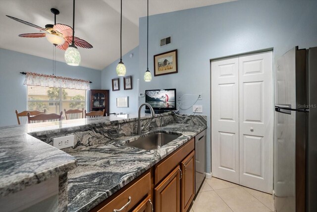 10764 70th Ave Unit 4305, Seminole, FL 33772 - kitchen with appliances with stainless steel finishes, brown cabinetry, ceiling fan, lofted ceiling, and dark stone countertops