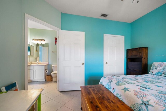 10764 70th Ave Unit 4305, Seminole, FL 33772 - bedroom featuring light tile patterned flooring and connected bathroom