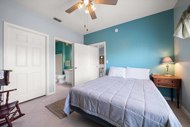 10764 70th Ave Unit 4305, Seminole, FL 33772 - bedroom featuring tile patterned floors, ensuite bathroom, and ceiling fan