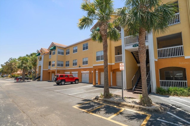 10764 70th Ave Unit 4305, Seminole, FL 33772 - view of building exterior featuring stairs and uncovered parking