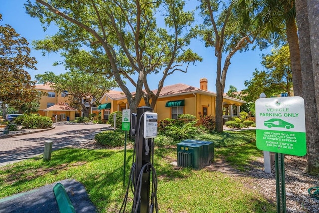 10764 70th Ave Unit 4305, Seminole, FL 33772 - view of front of home with stucco siding, a chimney, and a front lawn